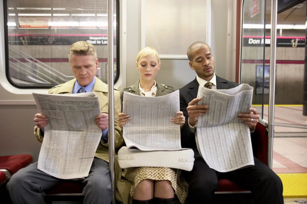 reading newspaper on the TTC subway